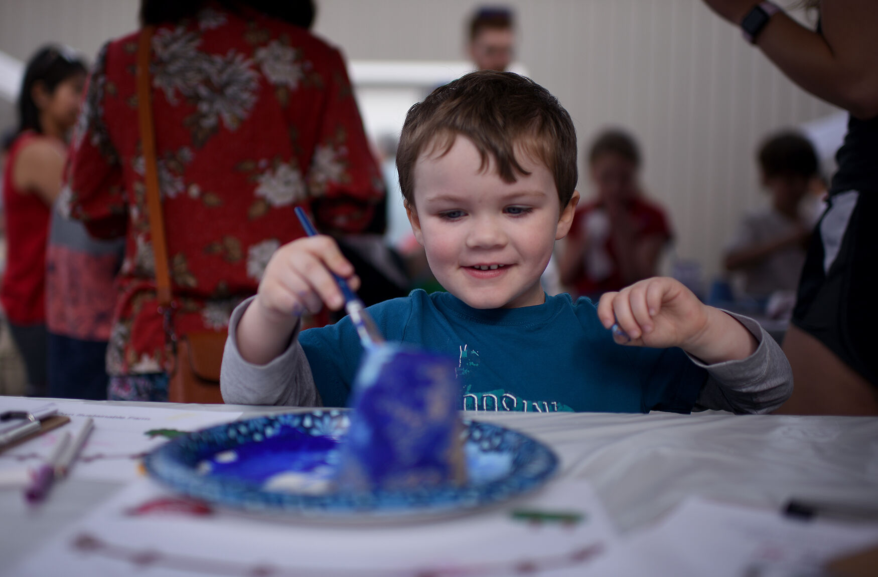 Malachi Hanna, 3, paints a pot on Thursday at the Missouri Rural Crisis Center